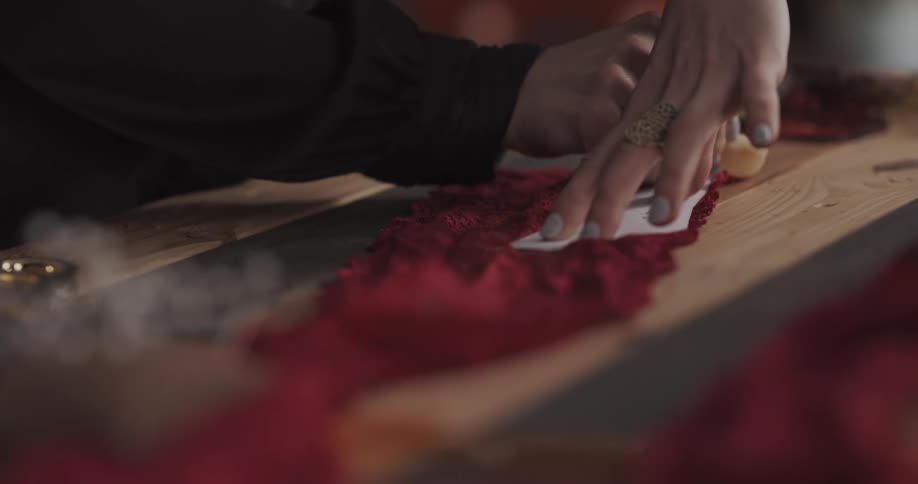 A woman traces a shape onto a piece of fabric