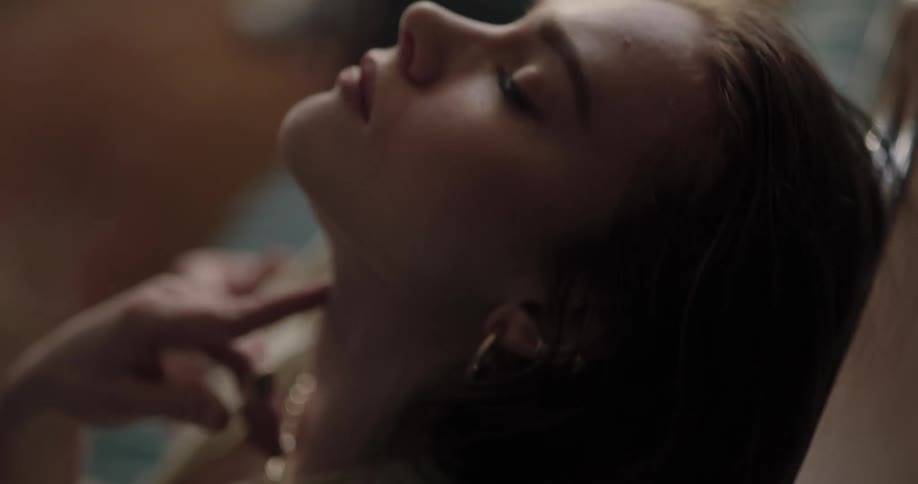Woman leans her head back and strokes her neck