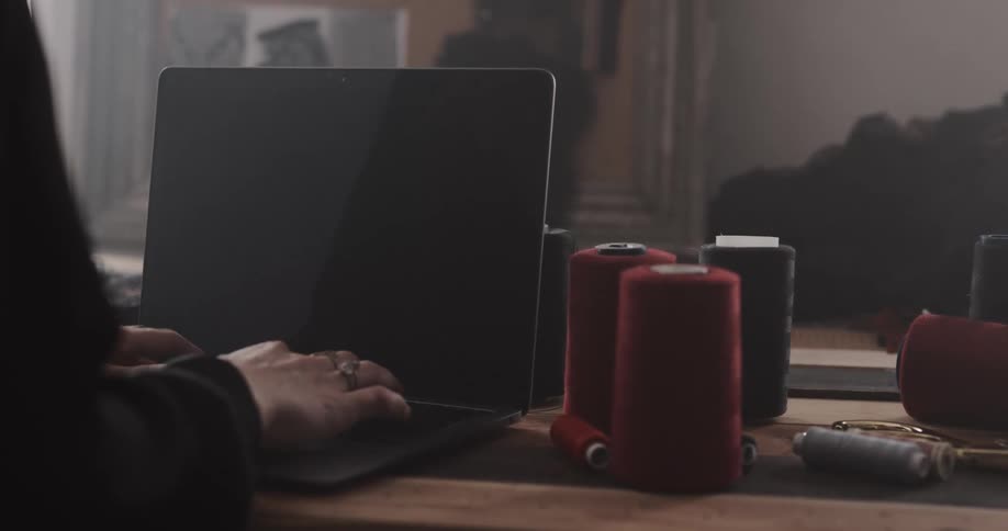 A person is typing on their laptop