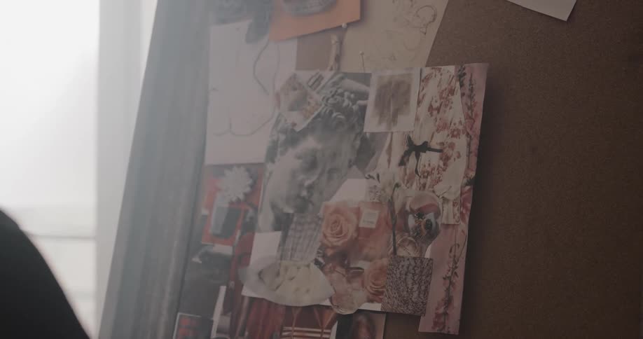 A woman pins images to her vision board