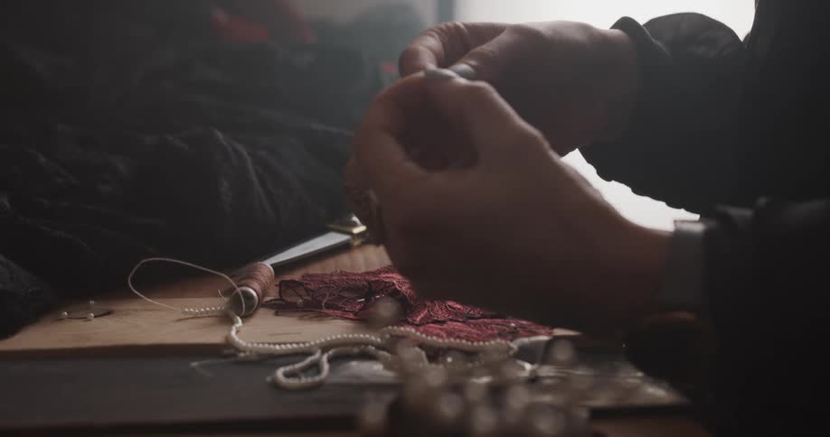 A person is sewing with a needle and thread
