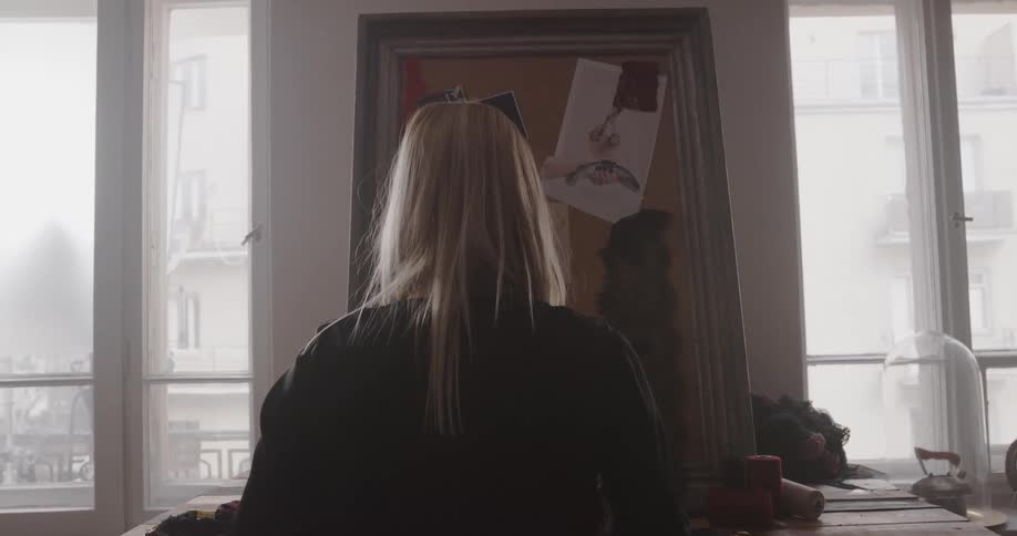 A woman is standing in a room in her house