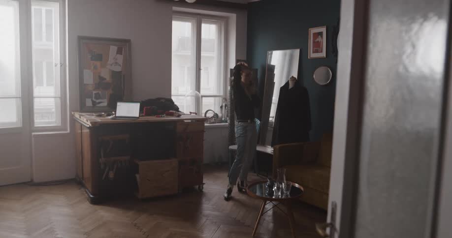 A woman walks back and forth talking on the phone