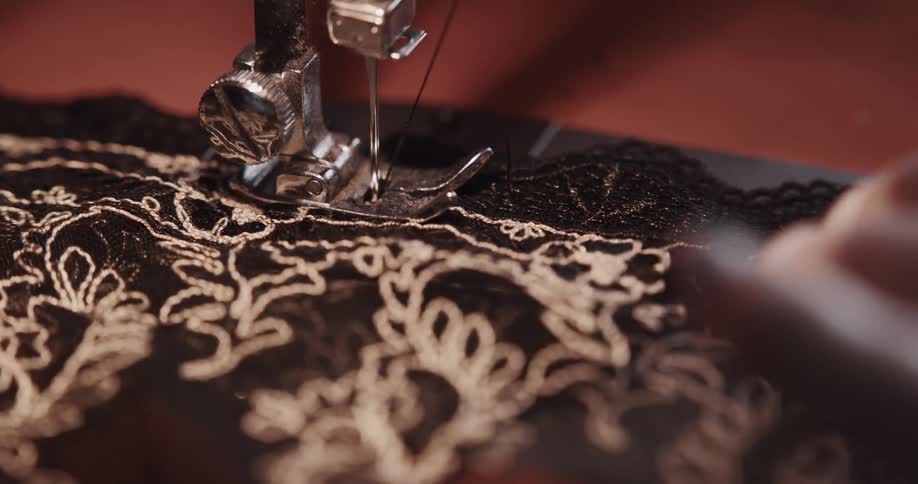 A person is using a machine to sew fabric