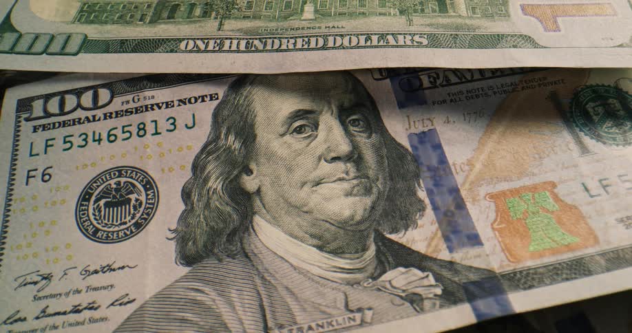 American bank notes lying atop one another on a surface