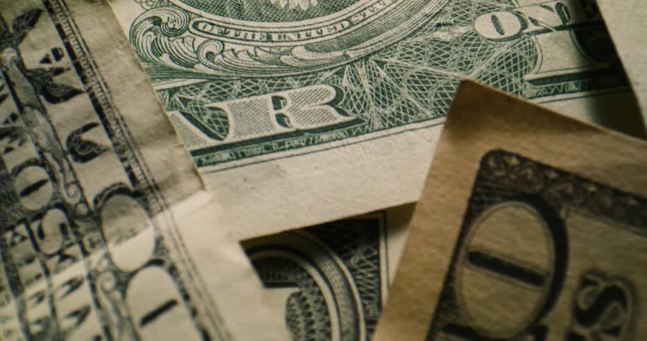 American paper currency in various denominations lie spread out