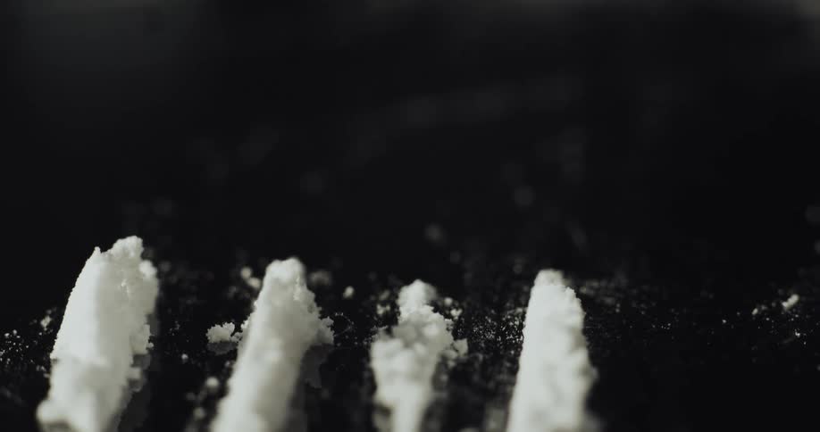 Lines of cocaine sit on a small mirror