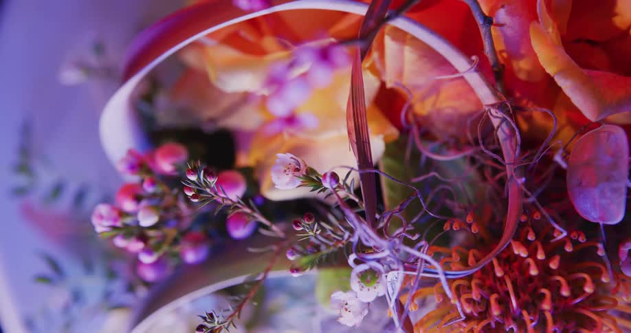 Multiple flowers of various bright hues contribute to elaborate floral arrangement