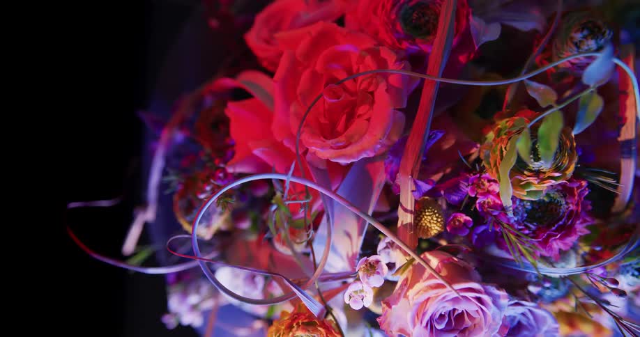 A colorful floral arrangement is full of many types of flowers