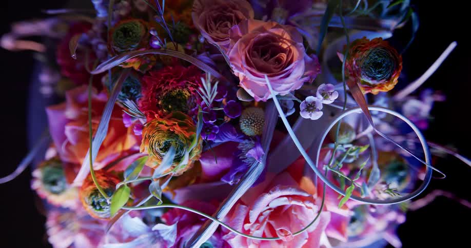 Floral arrangement contains bright multi colored flowers of different types