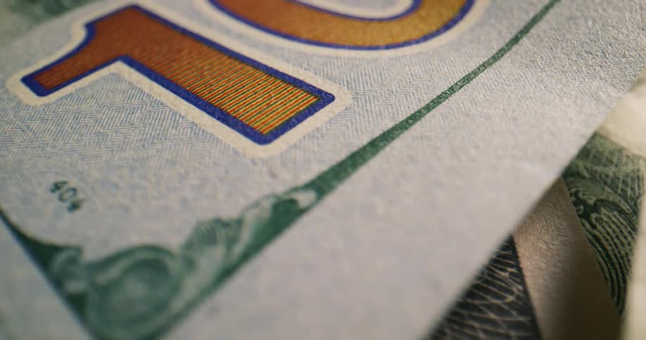 Several bills on various denominations are scattered on each other