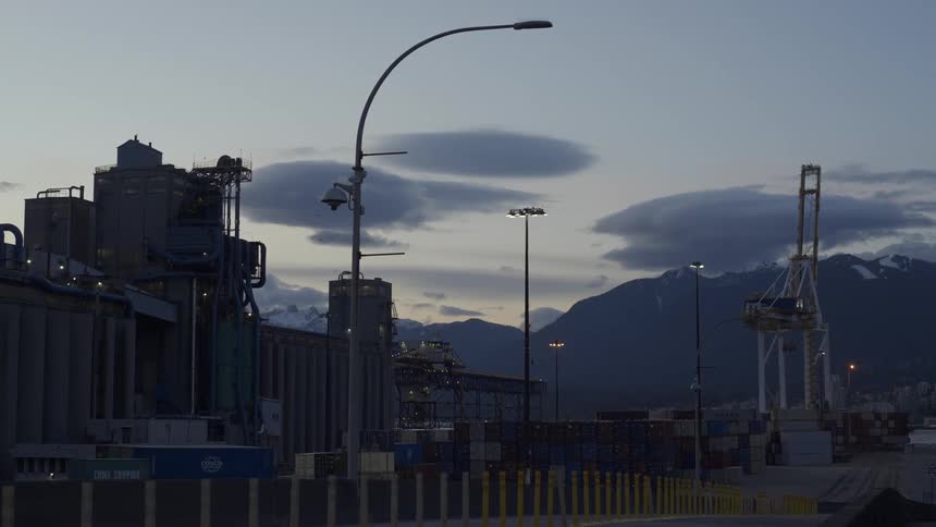 Vehicle enters a shipping yard at evening
