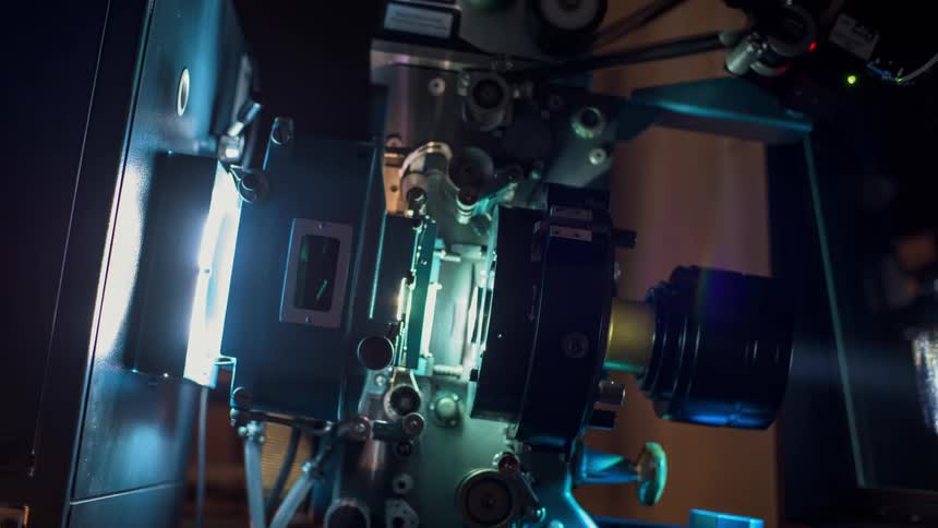 Film projector projects image onto glass window