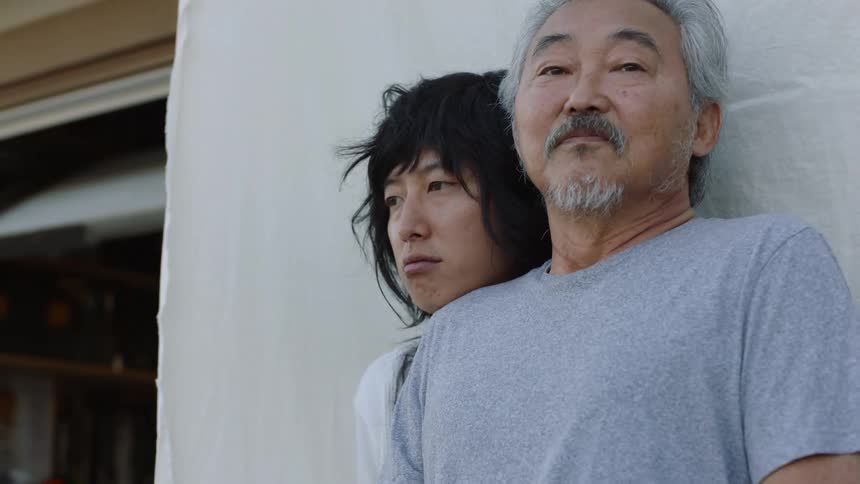 Two asian people stand outside together