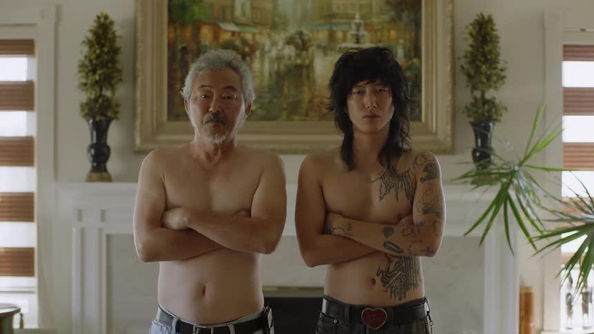 Father and son pose bare chested in front of mantel