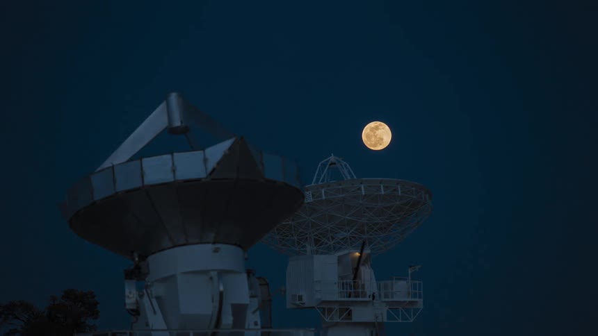 The full moon rises above a radio astronomy observatory