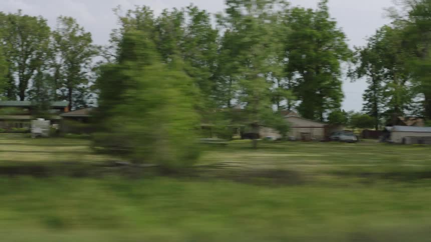 Trip through countryside passes houses with large yards
