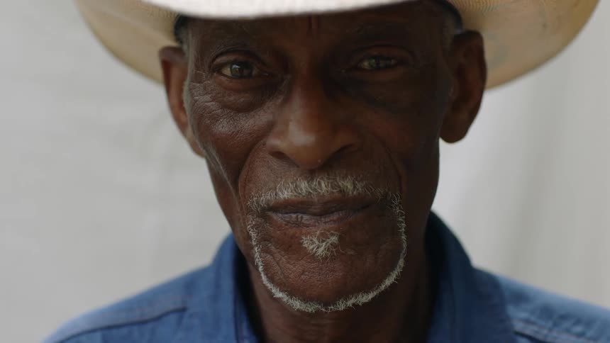 A man is wearing a cowboy hat