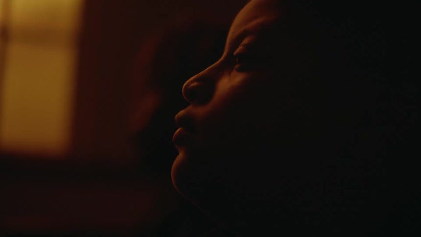 Side view of a young boys face in a dark room