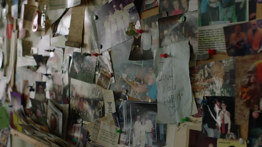 Bulletin board hanging from a wall at home filled with pictures and drawings