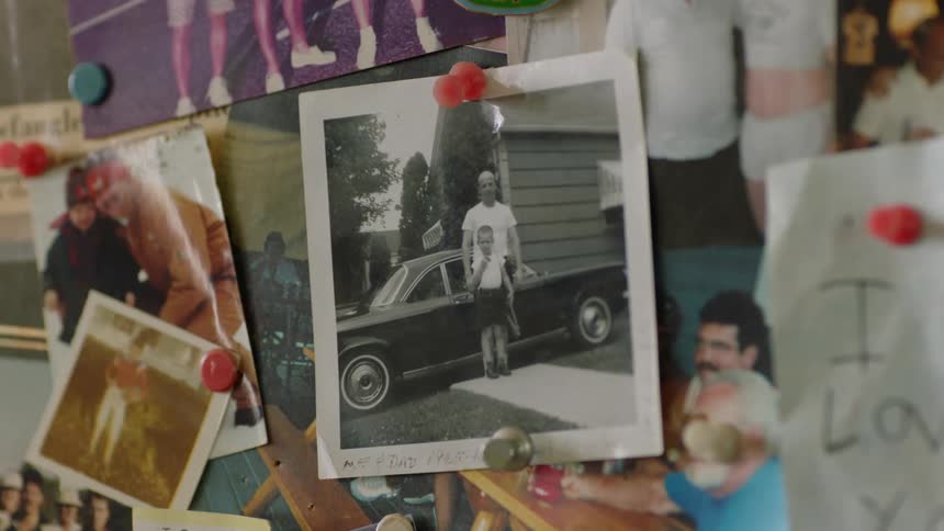Pictures and photographs are tacked onto wall