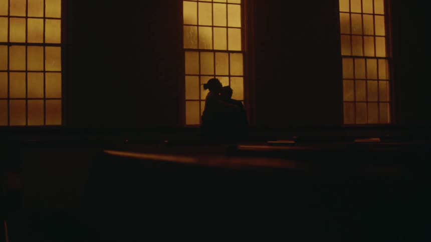 Silhouette of a adult person embracing a smaller person