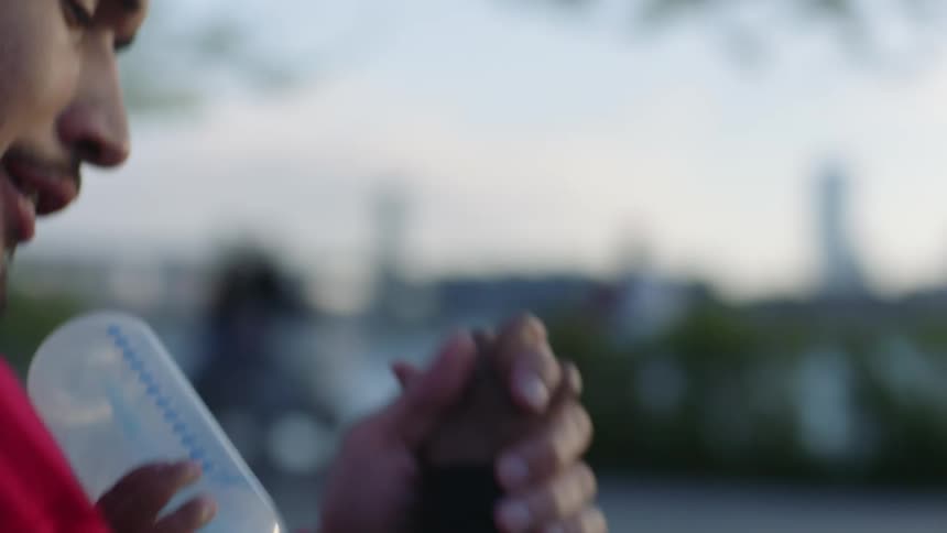 A father feeds his son a bottle