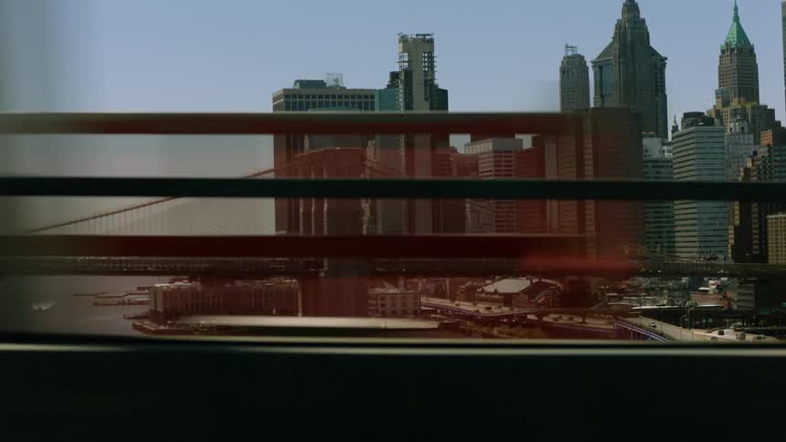 Traveling across the manhattan bridge looking at the city skyline and the brooklyn bridge
