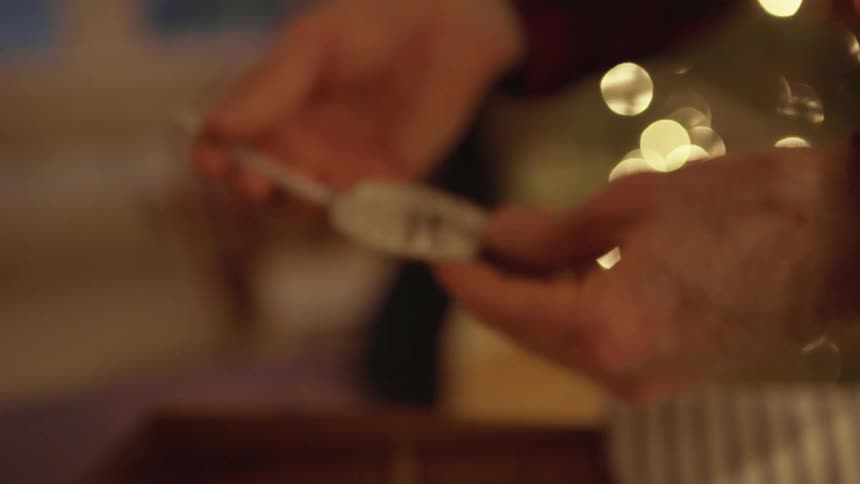 Person takes an ornament out of a box