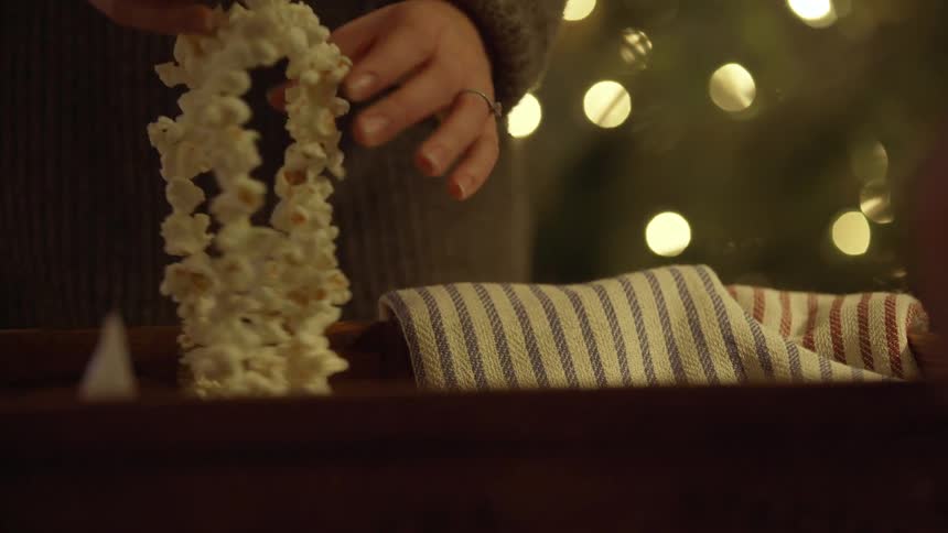 People are hanging a popcorn garland
