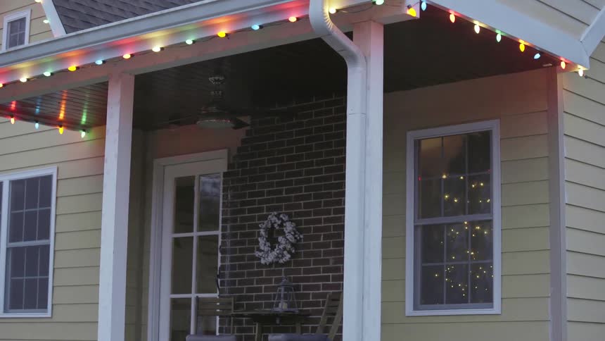 Christmas lights glow on the exterior of a house