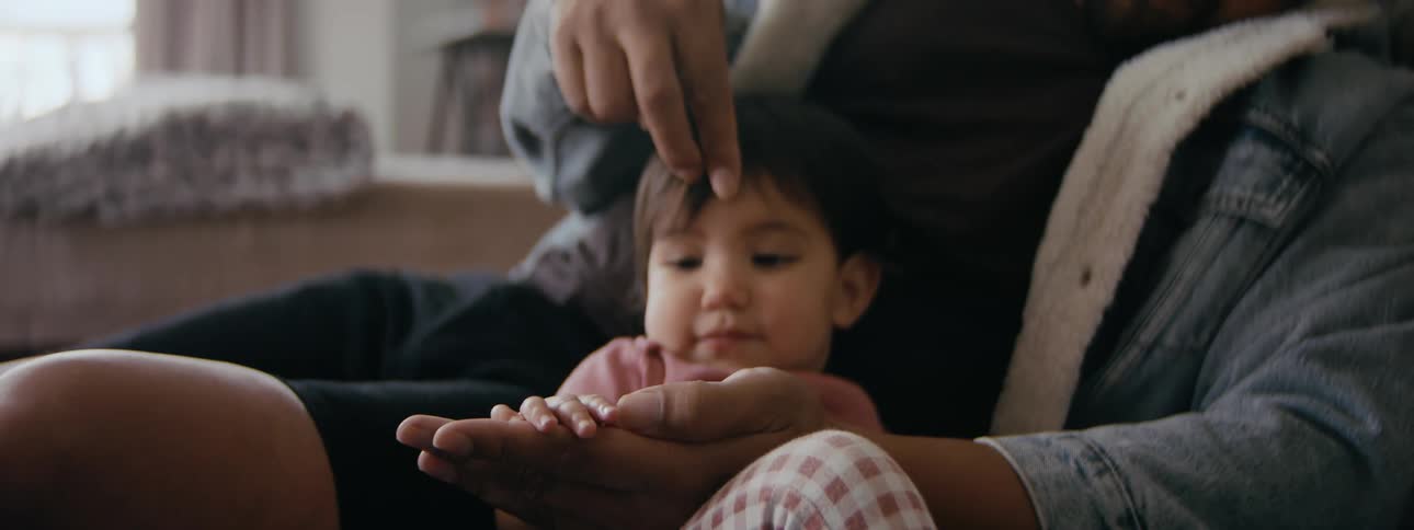 A father playing with his baby at home