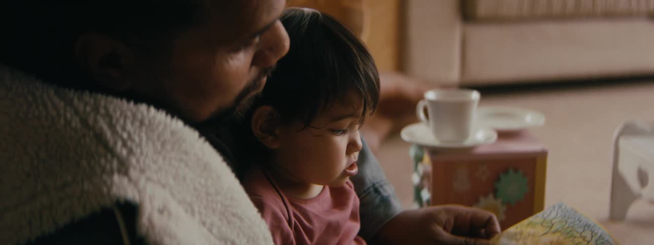 A father and child are reading together