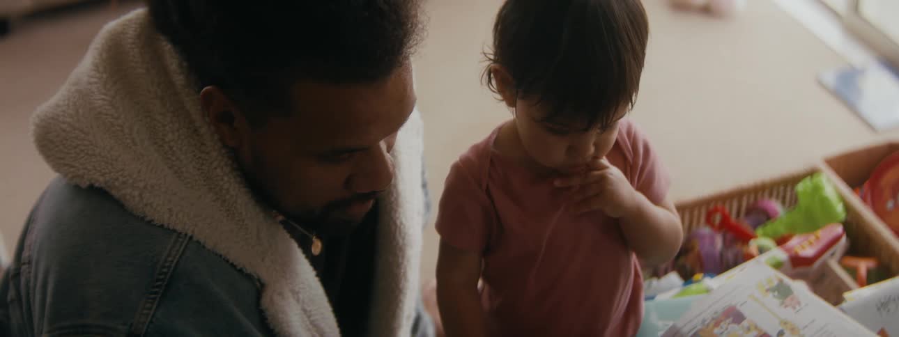 Father reading a picture book to his toddler