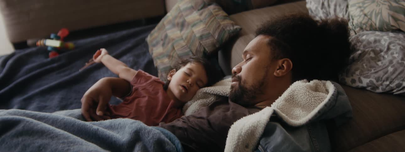 A father and son sleep in the bed
