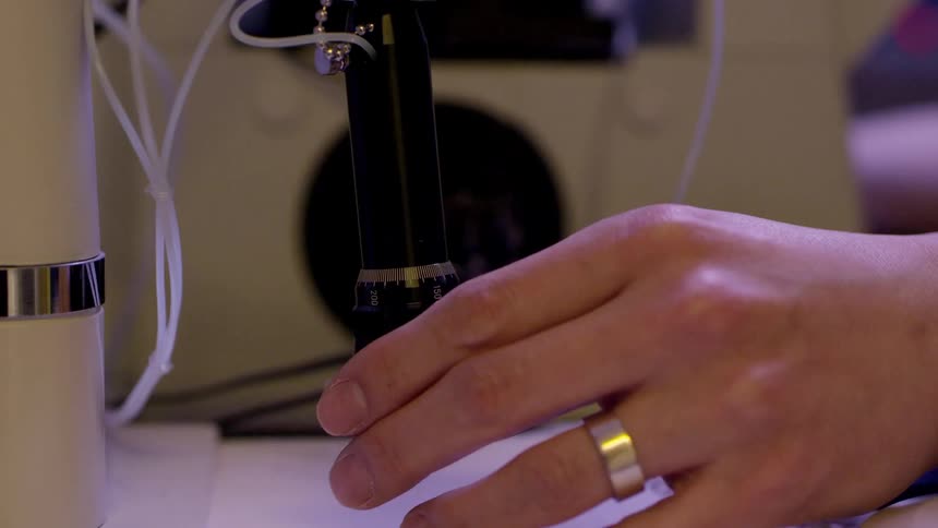 A person is using a microscope