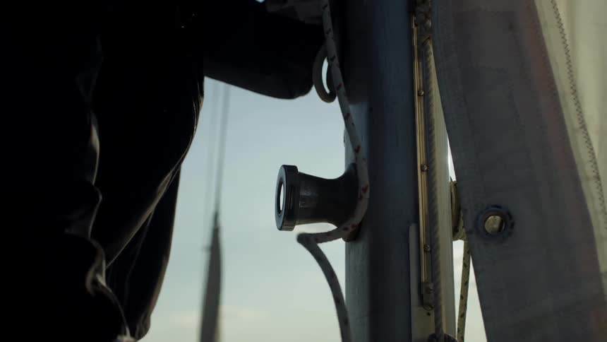 A man ties a rope on a boat