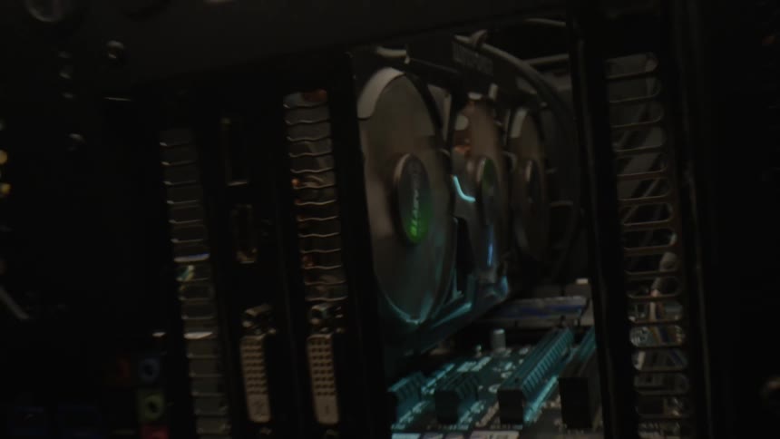 The spinning drives of a computer glowing inside a case