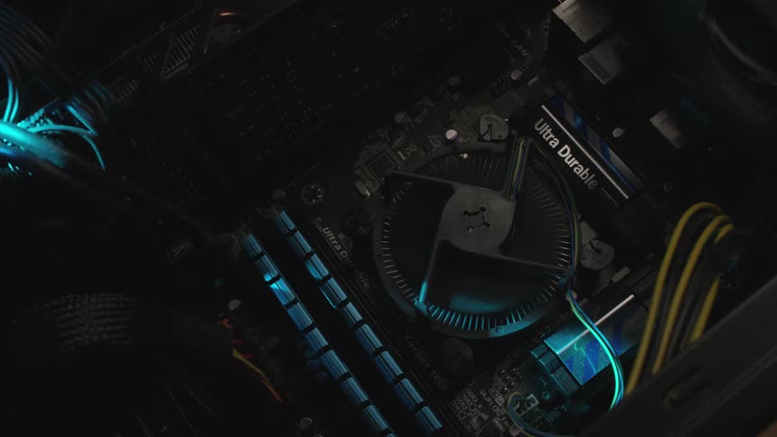 A blue light passes over a circuit board with wires fan and spinning disk