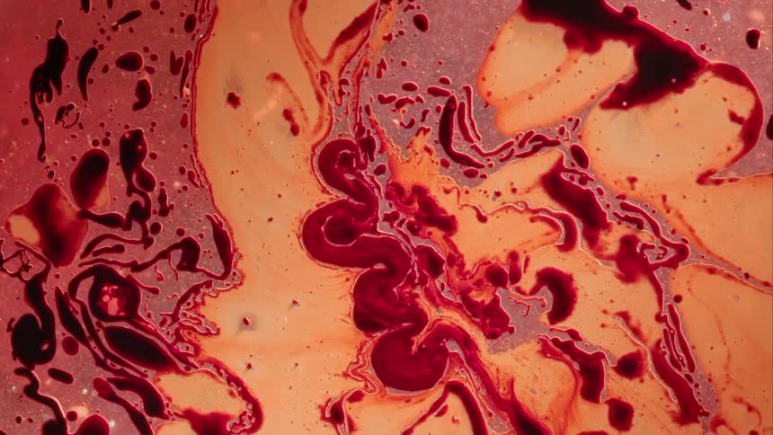 Red and yellow paint spreading close to each other