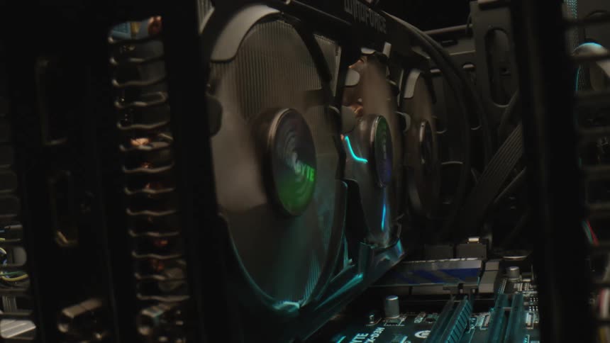 Cooling fans spinning on a graphics card within a computer case