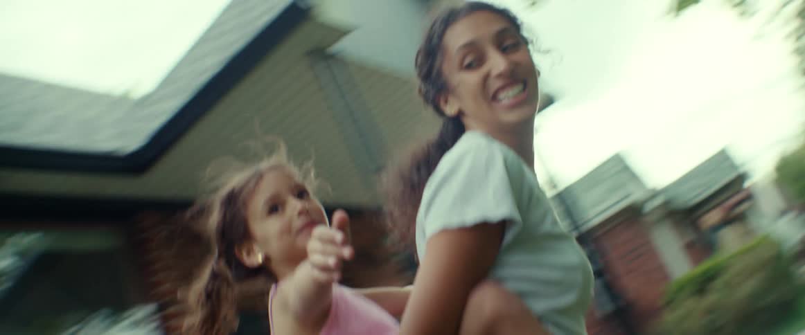 Two girls are playing outdoors during the spring