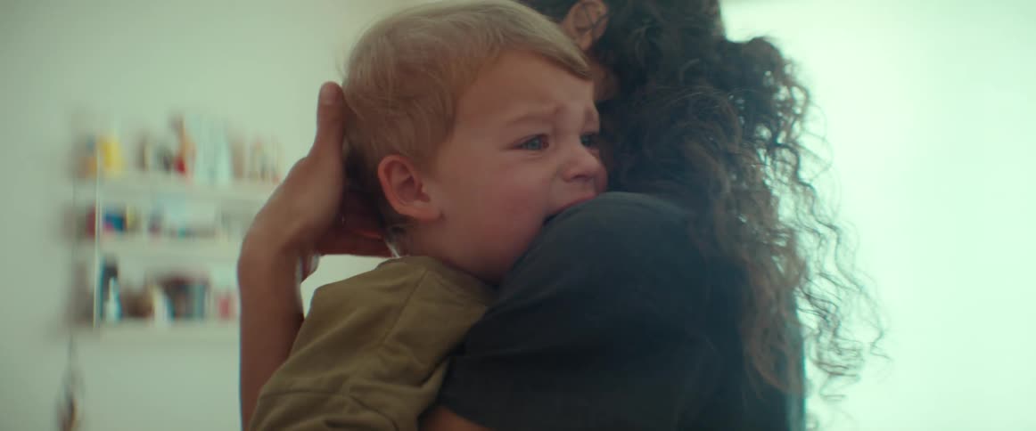 A mother comforting and rocking her crying baby boy