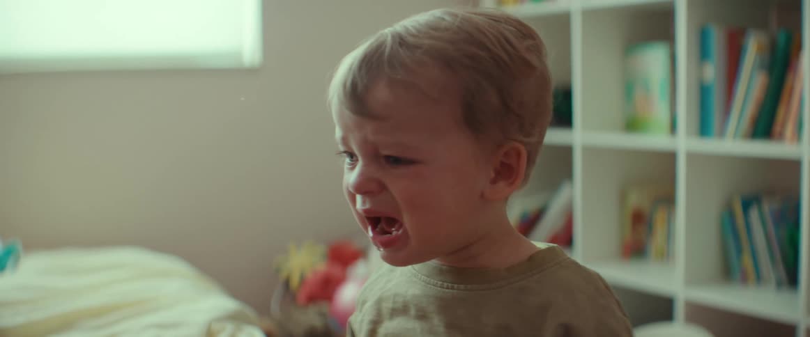 A son is crying in a room next to his mother
