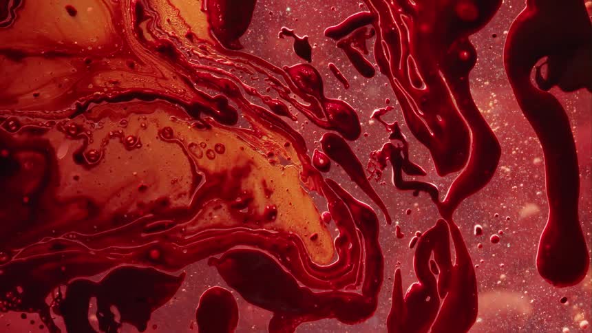 And dark orange and red liquid swirls and mixes together in an artistic looking way