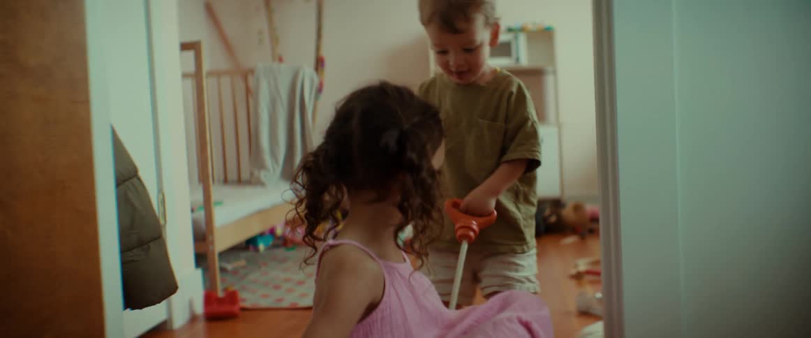 A boy and girl are playing together during the day time