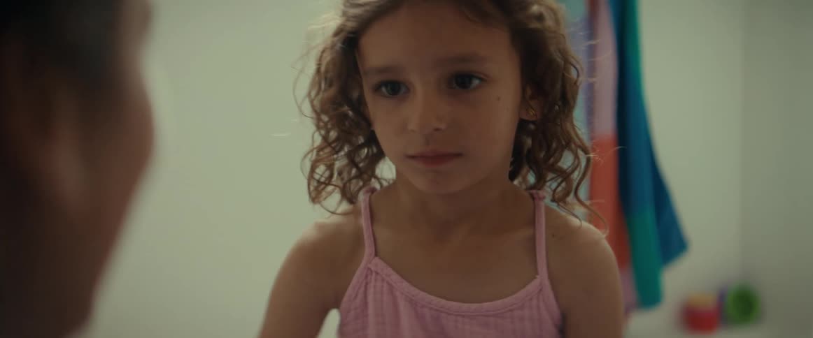 Mother puts bandage on girls knee then girl hugs mom