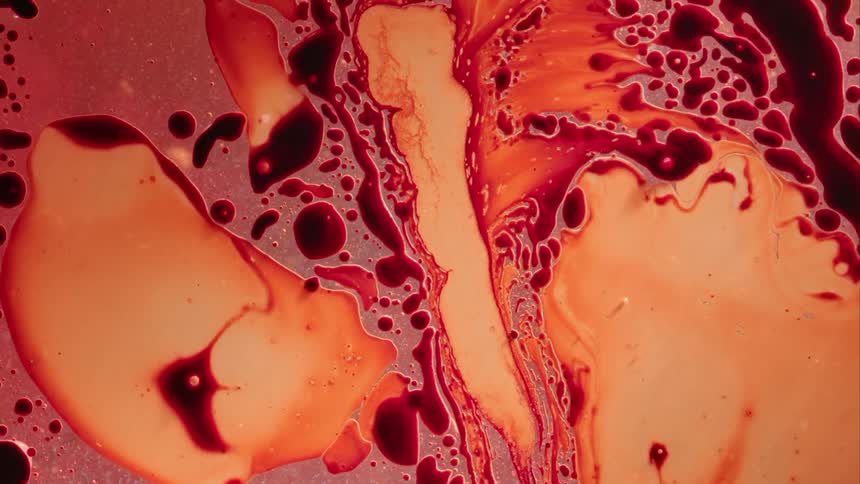 And orange hued fluid swirls and mixes together in an abstract manner