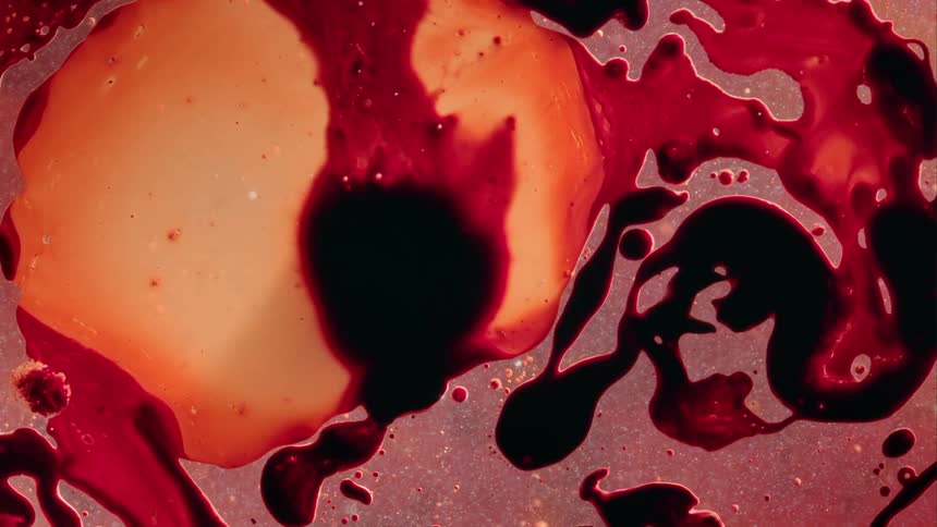 A dark spot grows inside a bubble like an amoeba as it blends into the lighter color and the outside shapes move as it grows