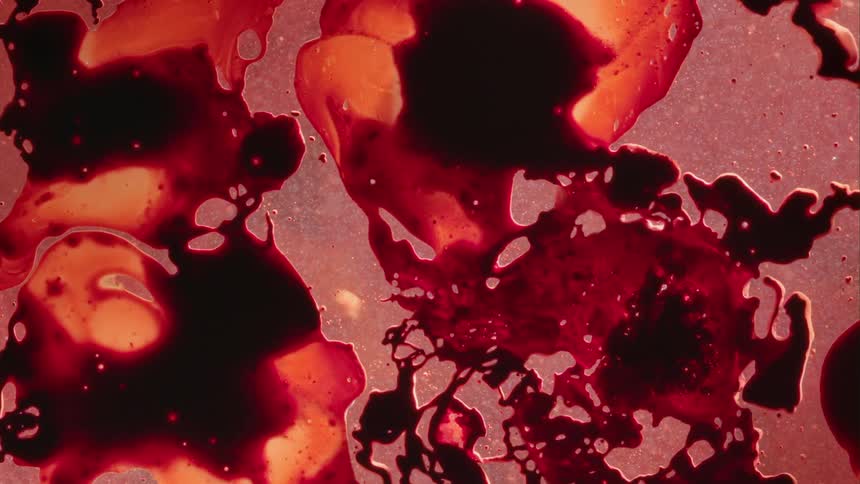 Blobs of thick liquid expand and blend together